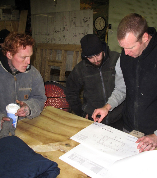 Michael Riley, left, and another trainee look on as Ryan Ahern, Bread Loaf Corp.'s director of safety and training, examines architectural drawings